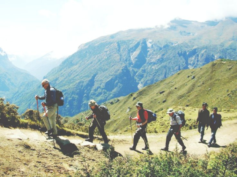 Tourist trekking the mountains with tourist guide