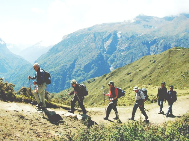 Tourist trekking the mountains with tourist guide